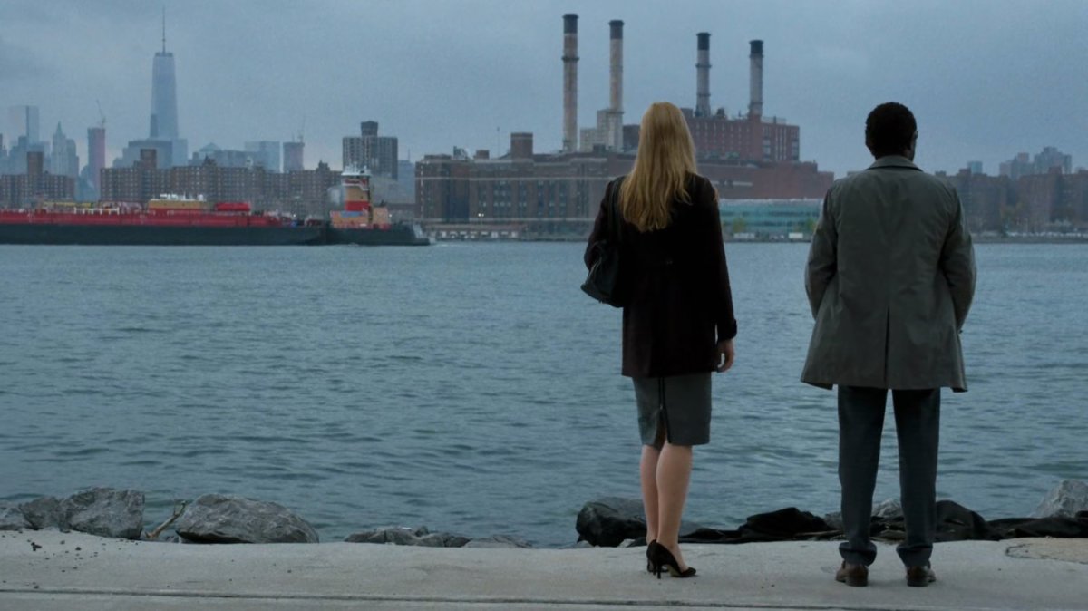Karen and Ben standing by the East River.