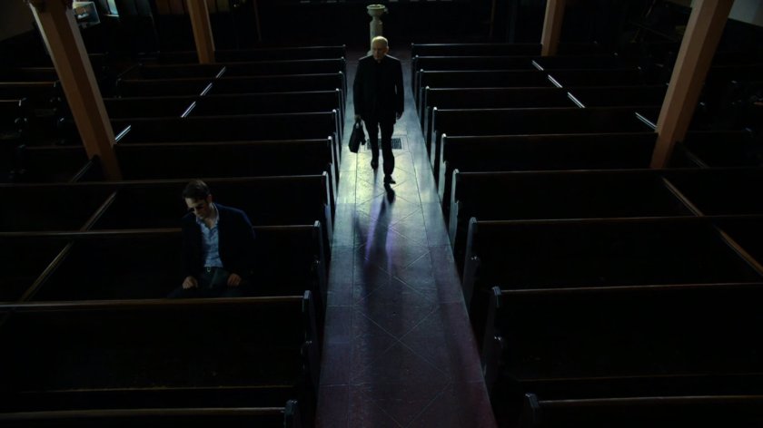 Matt and Father Lantom in church pews.