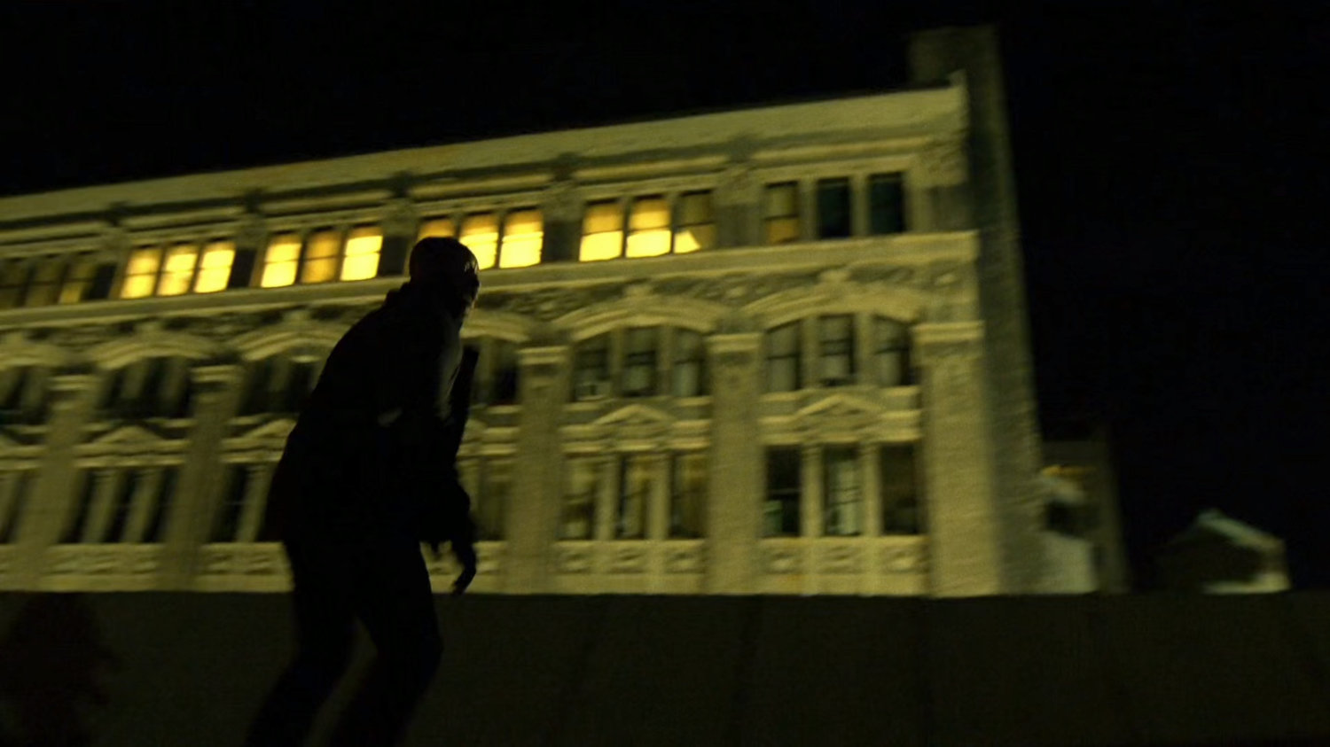 Turk running across a rooftop.