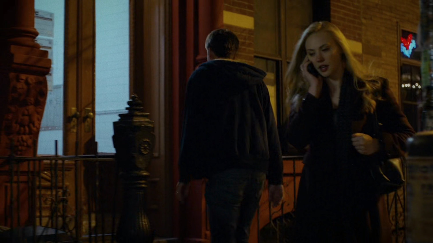 Karen talking on the phone while walking on sidewalk.