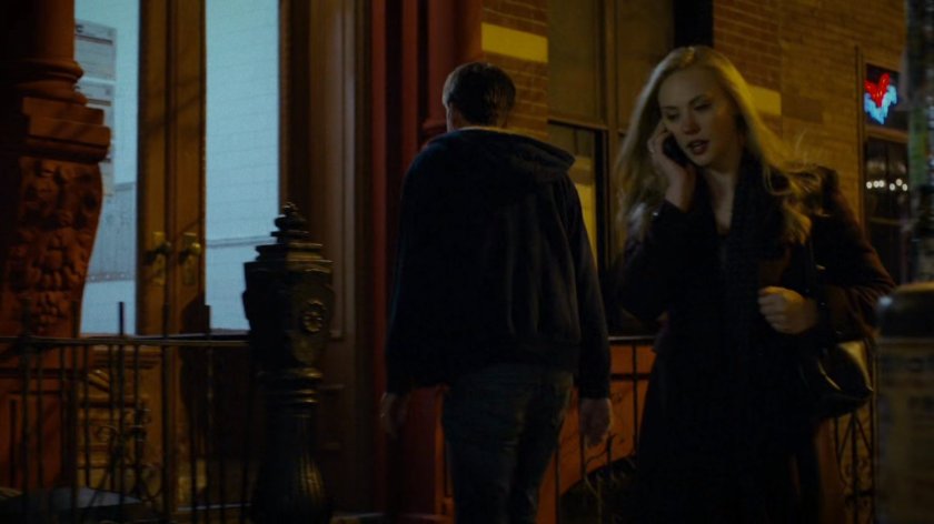 Karen talking on the phone while walking on sidewalk.