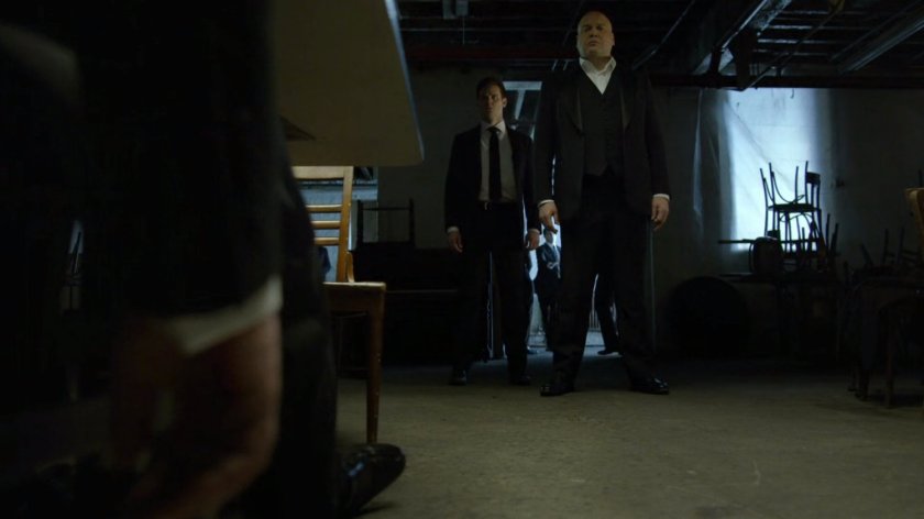 Fisk viewing Wesley's body in a dark basement.