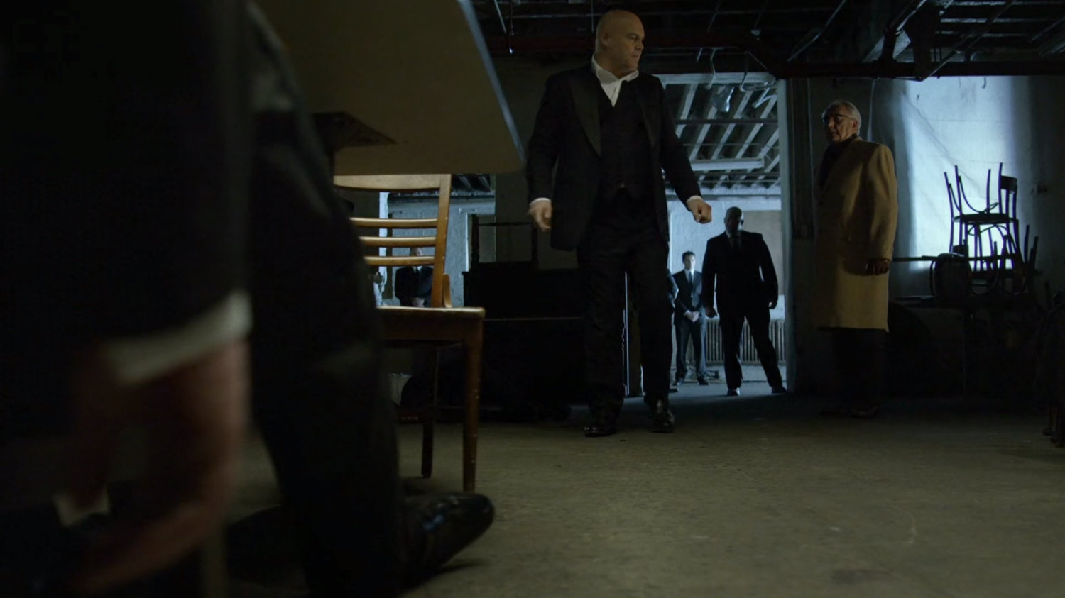 Fisk and Leland in a dark basement.