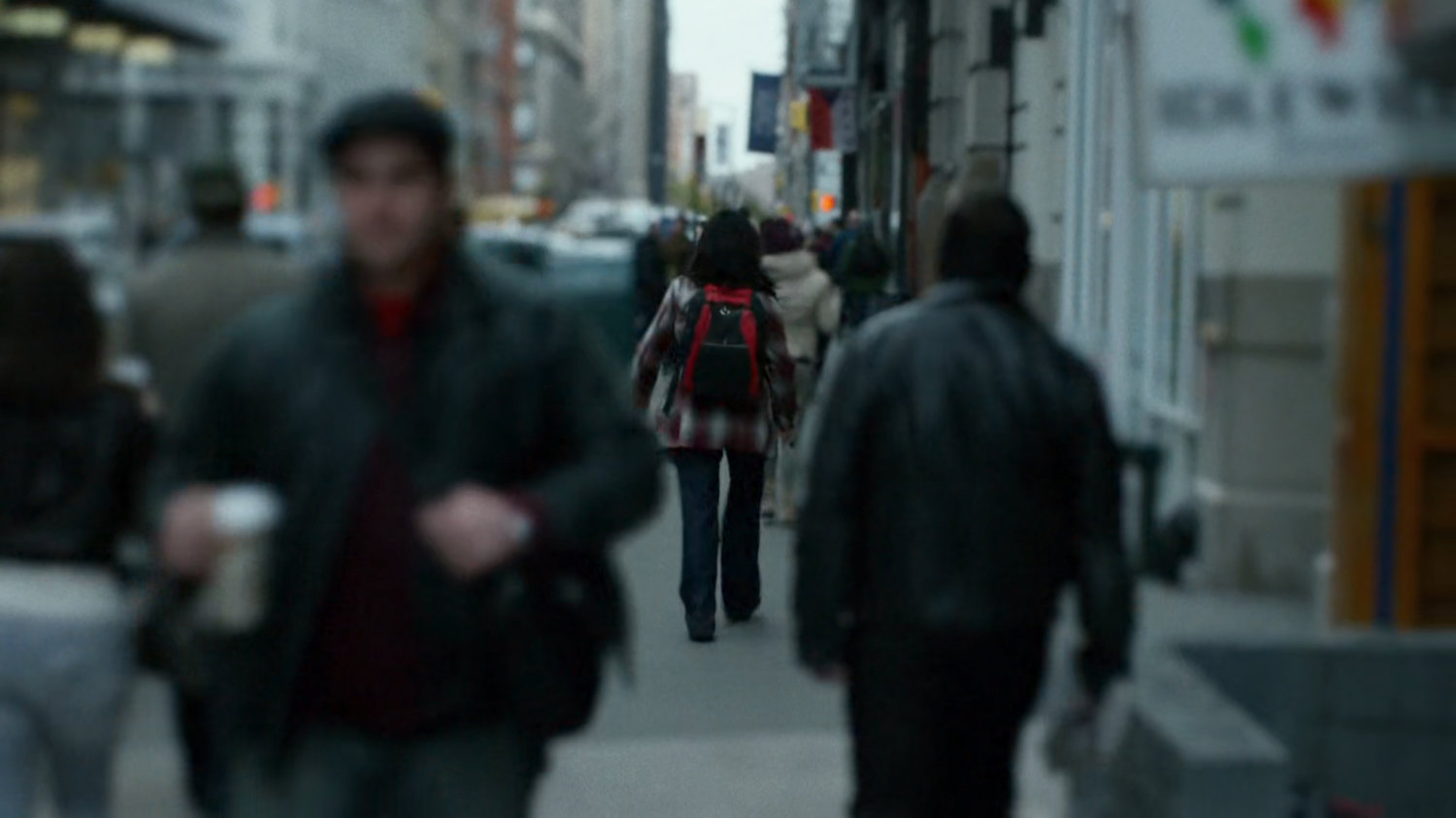 Courier with backpack of traffic packed New York street.