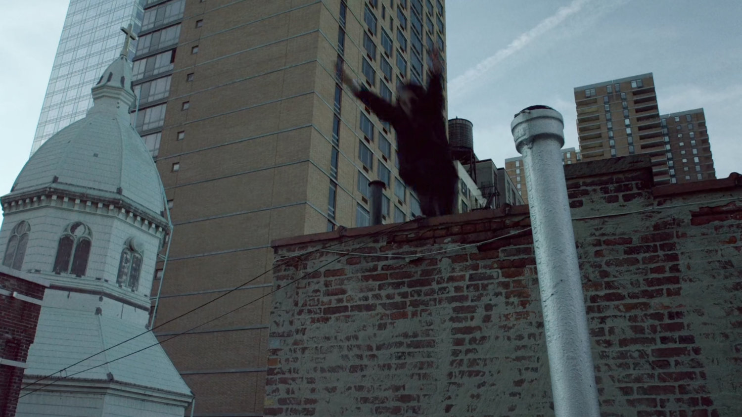 Matt vaults onto New York rooftop.