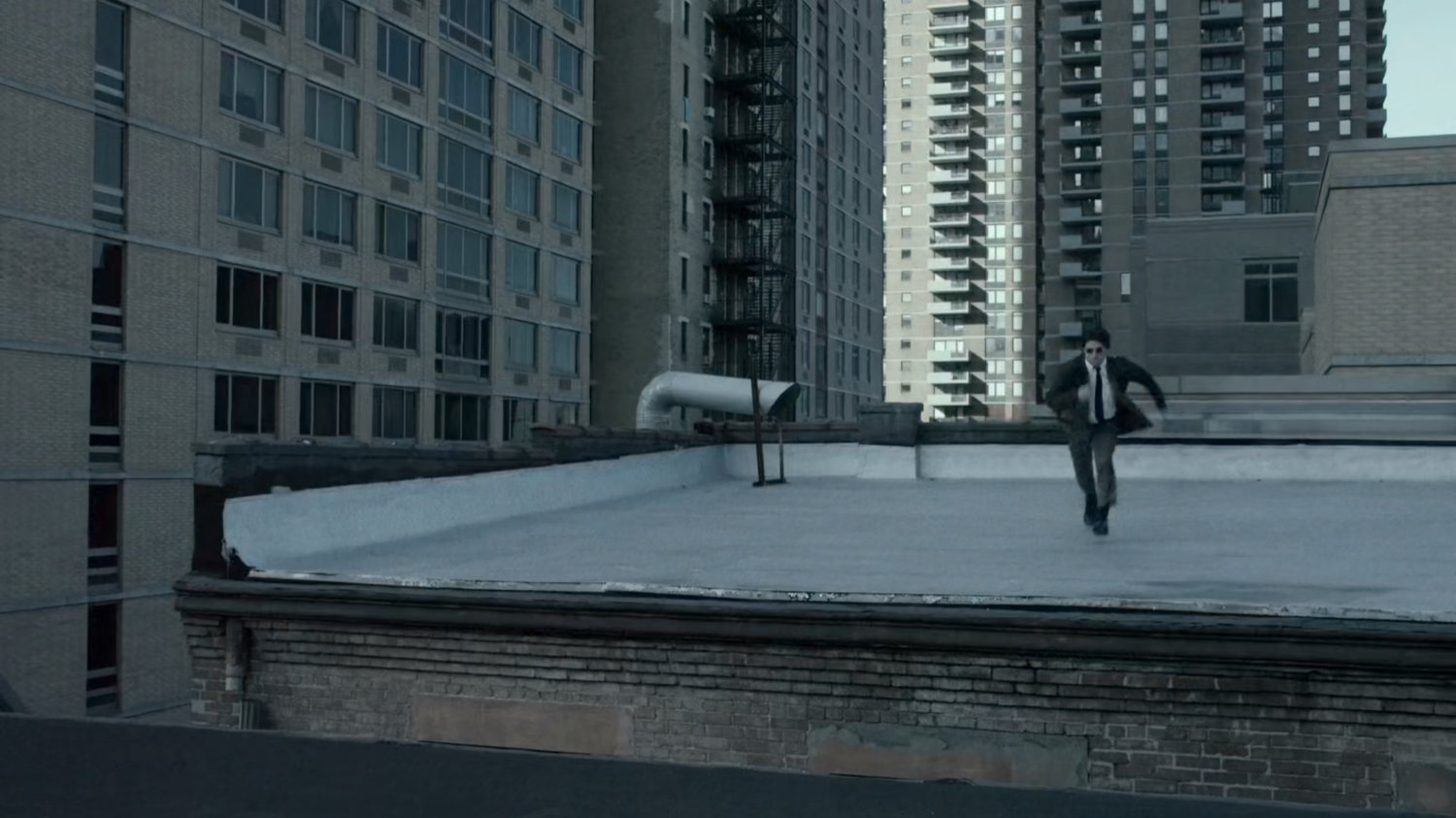 Matt runs across New York rooftop.
