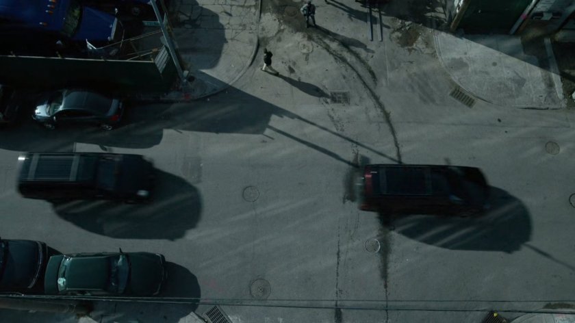 Aerial view of Fisk motorcade driving past junkyard by East River.