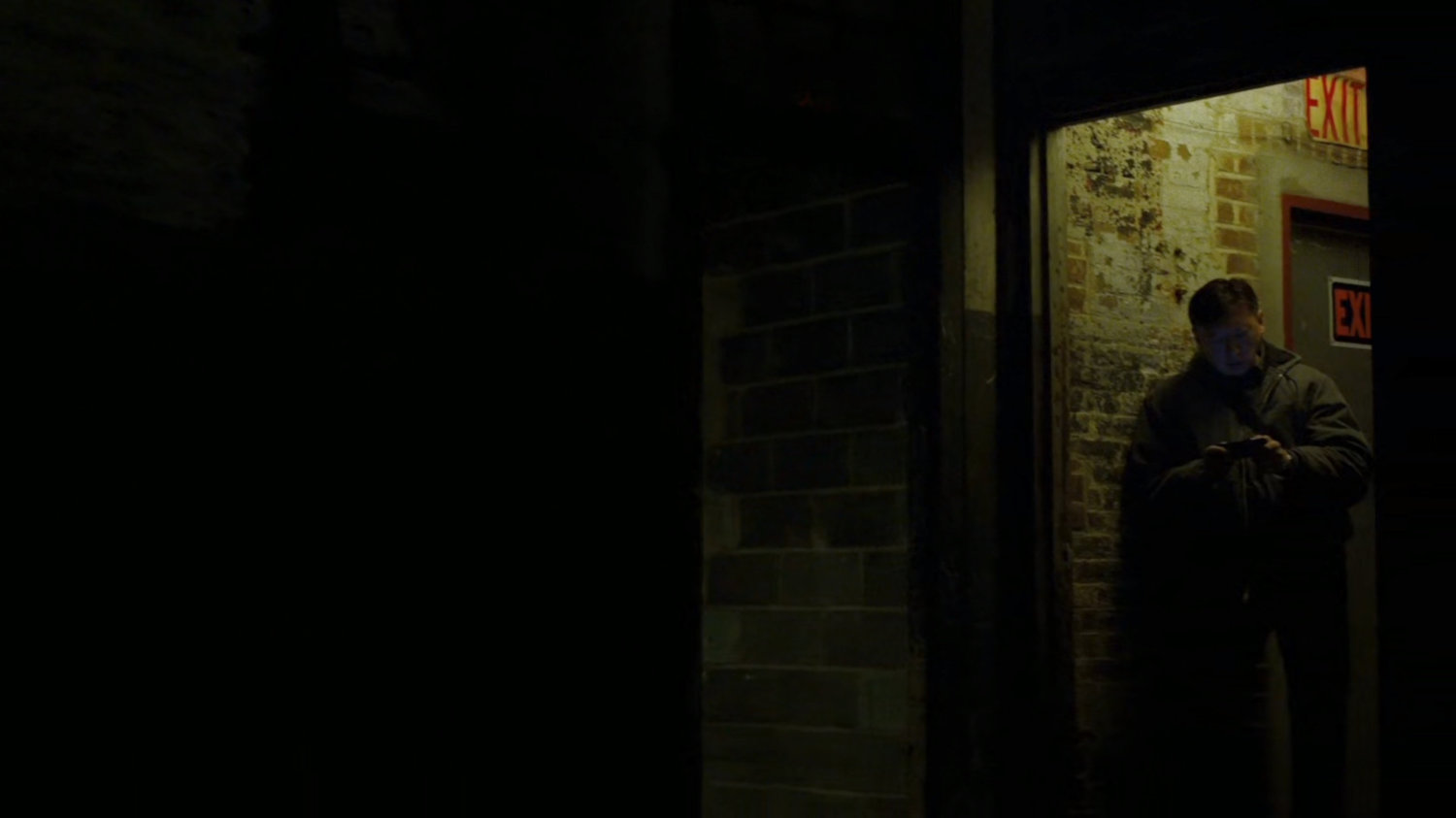 Guard in doorway of Gao's warehouse.