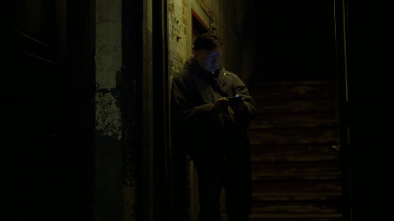 Guard in doorway of Gao's warehouse.