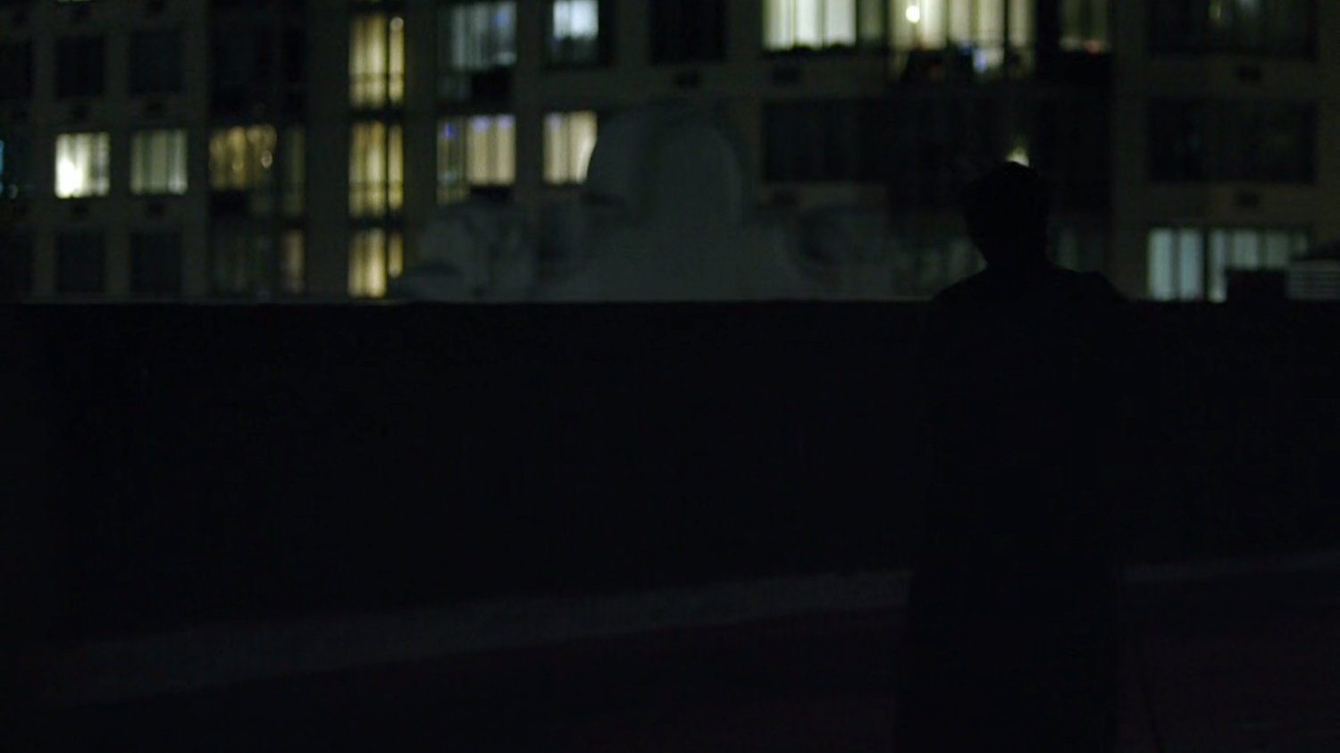 Madame Gao walks across a dark midtown rooftop.