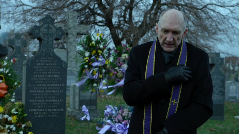 Father Lantom at cemetery.