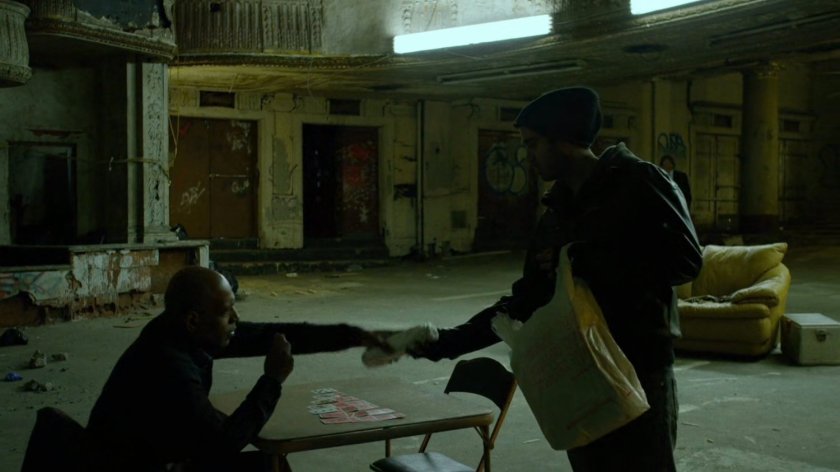 Detective Hoffman getting a sandwich inside abandoned theater.