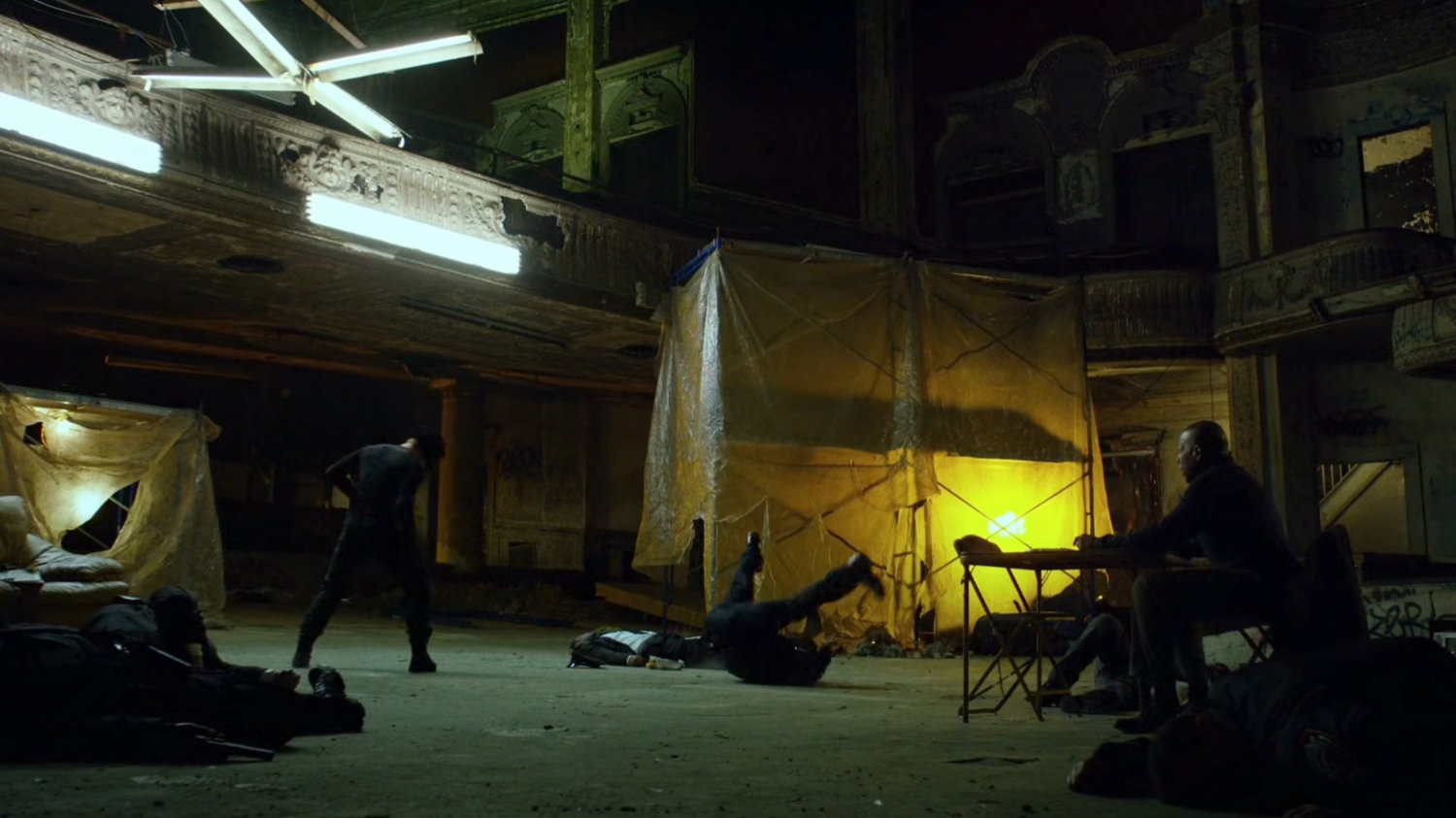The Man in Black stops cops inside abandoned theater.