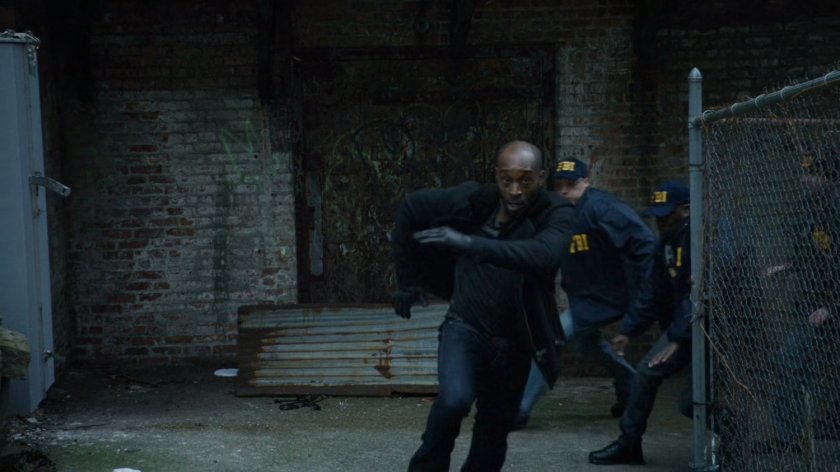 Turk runs through alley from FBI agents.