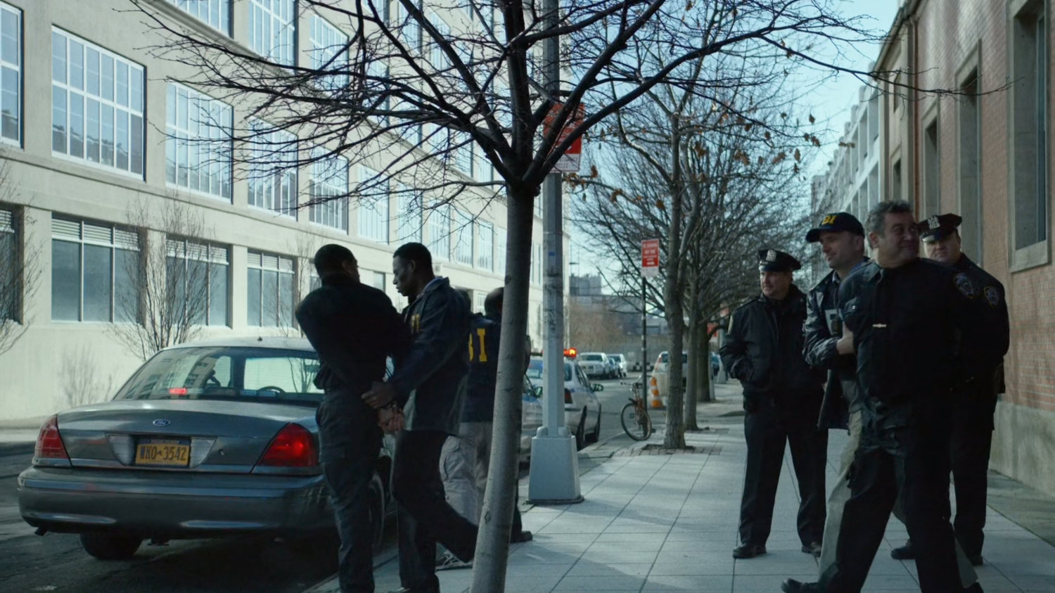 Police escorting other officers from the front of 15th Precinct.