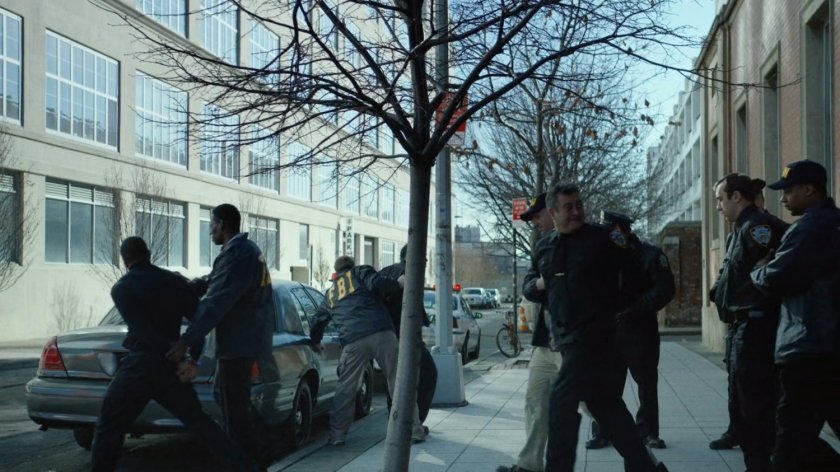Police escorting other officers from the front of 15th Precinct.