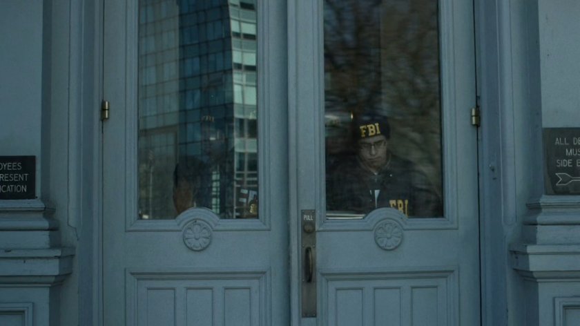FBI agents exiting Senator's office building.