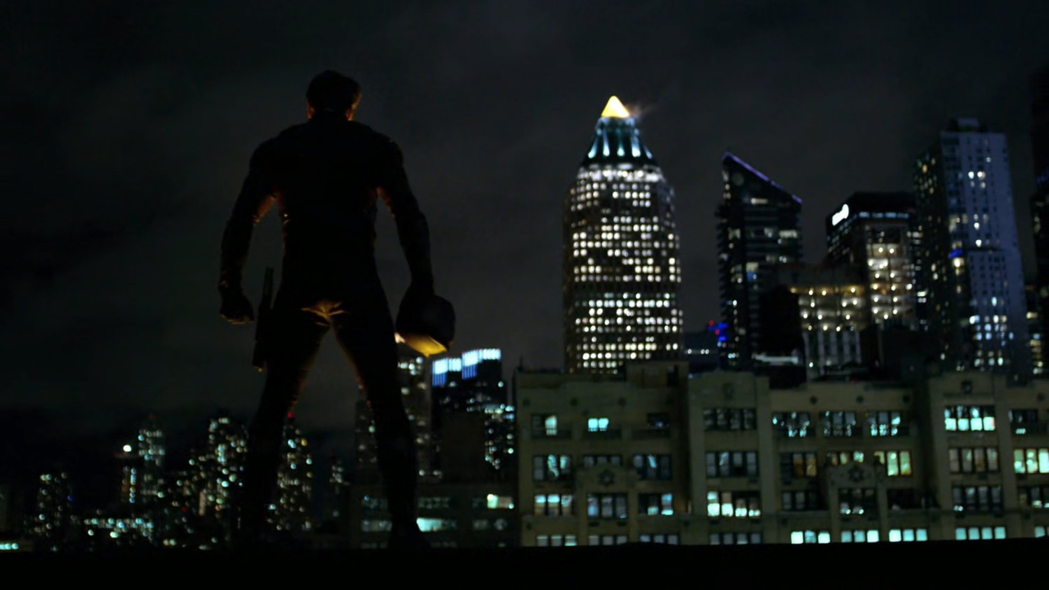Matt in his new costume on a rooftop.