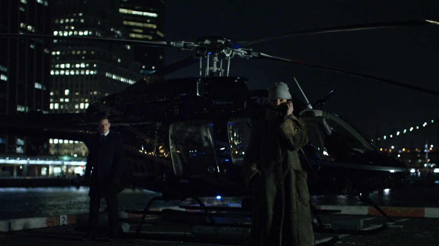 Vanessa by a helicopter at a heliport.