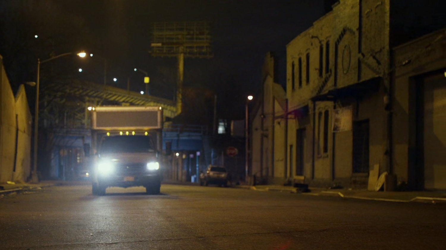 Truck driving along city street.