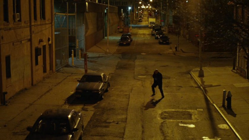 Wilson Fisk runs across a street.