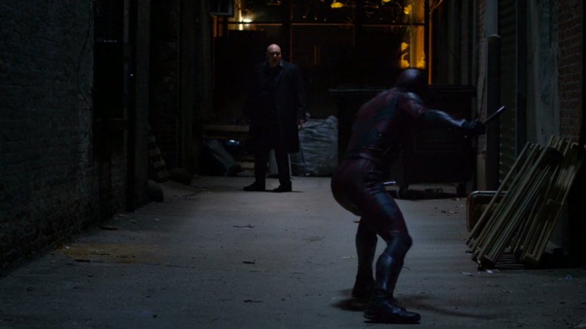 Fisk confronted by Daredevil in alley.