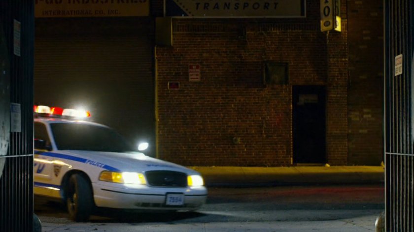 Police car entering alley.