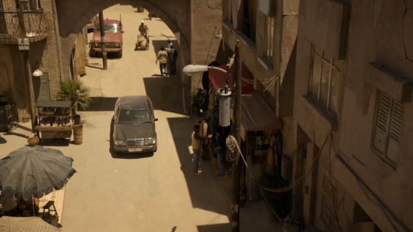 Black sedan on dusty street in Tangier.