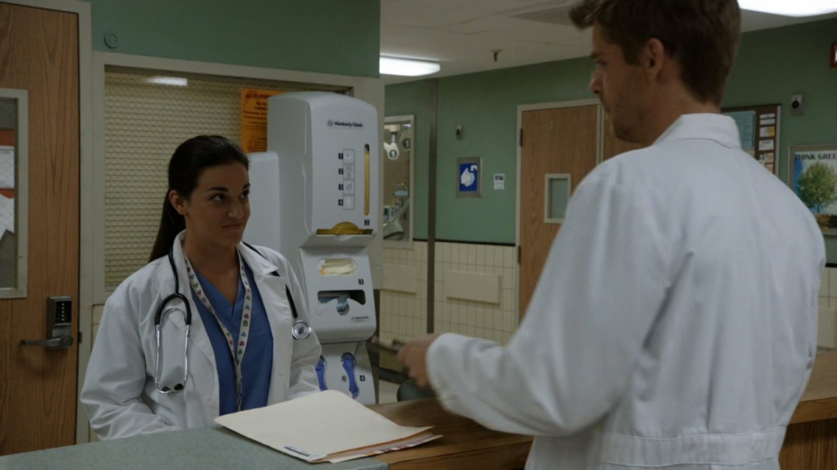 Lincoln and another doctor at a nurses station in hospital.