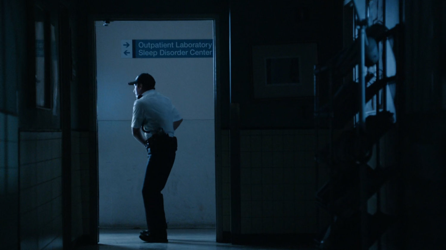 Guard in hospital hallway.