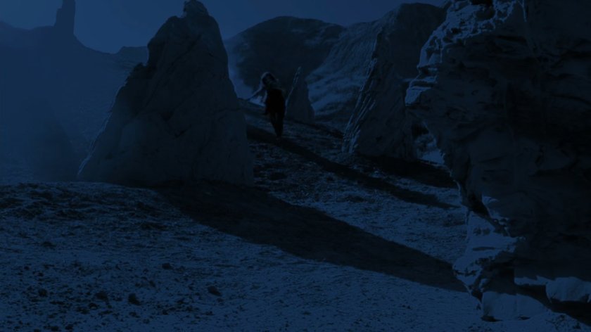 Simmons running past rocky spires on Maveth.