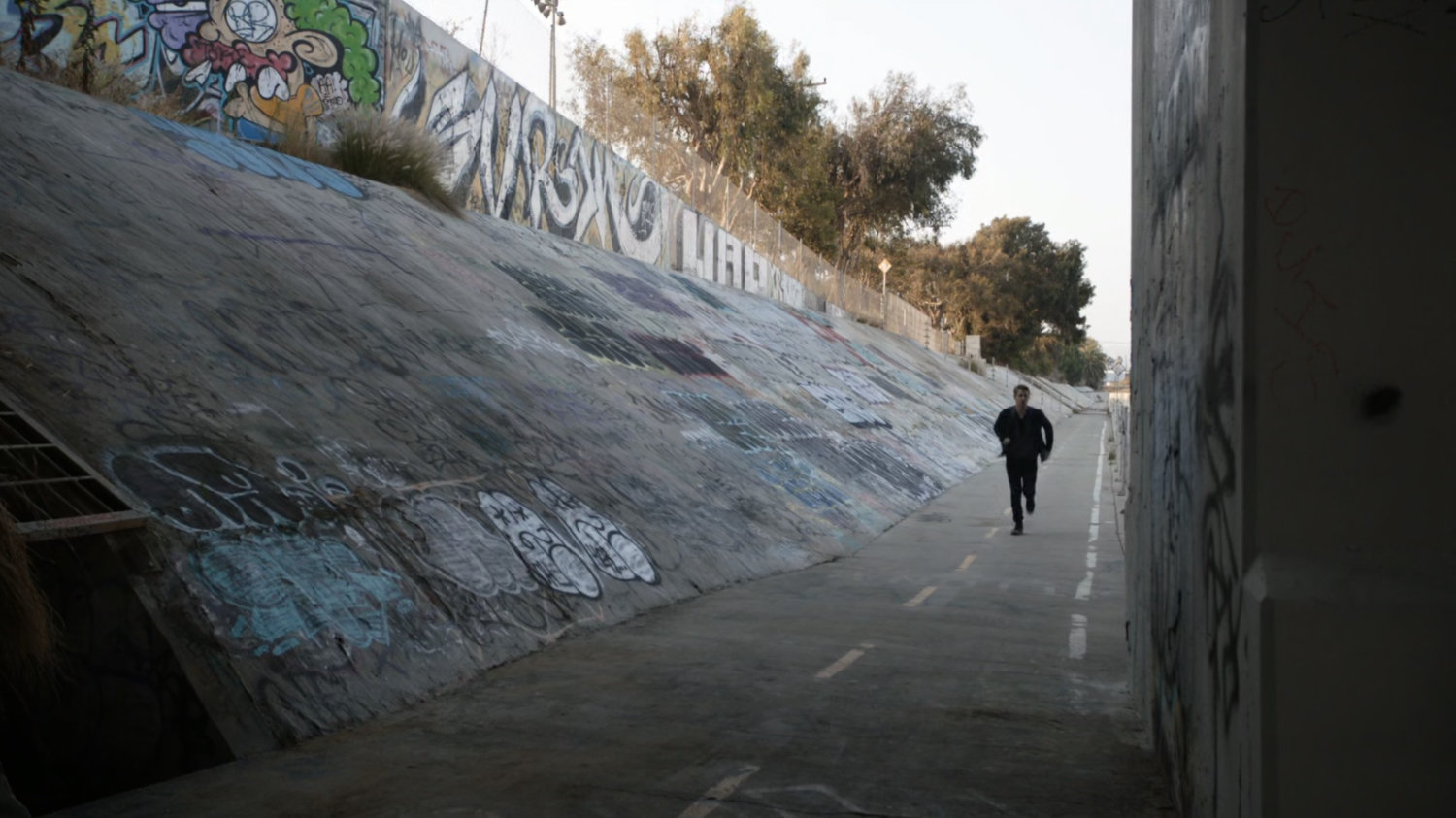 Lincoln running along concrete embankment.