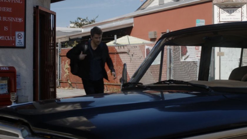 Lincoln exits corner market to Donnelly's truck.