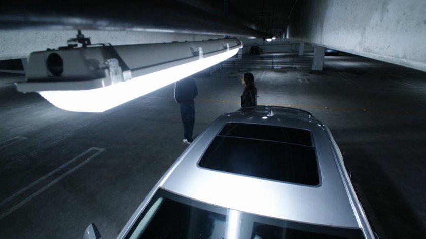 Hunter and May discuss tactics in a parking garage.