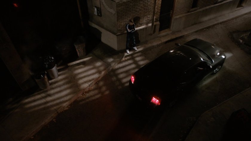 Hunter stands in dark back alley in Massachusetts waiting for car.