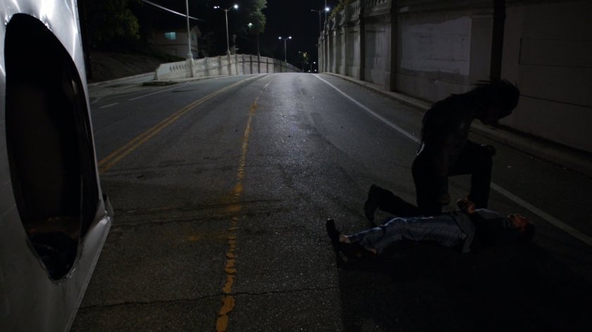 Lash stands over the body of Dwight Frye at van crash.