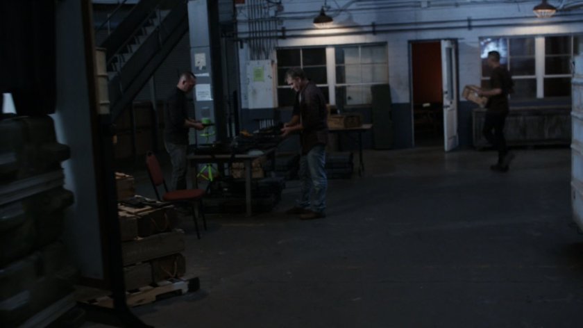 Men gathering supplies in a HYDRA warehouse.