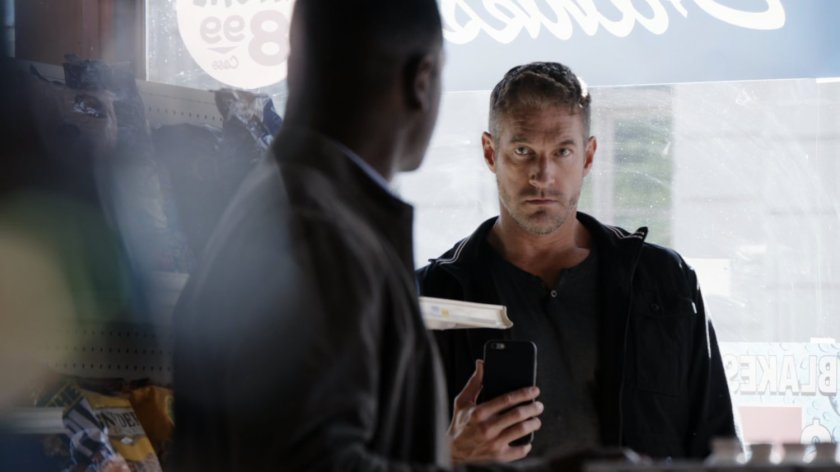 A HYDRA agent filming Andrew in a convenience store.