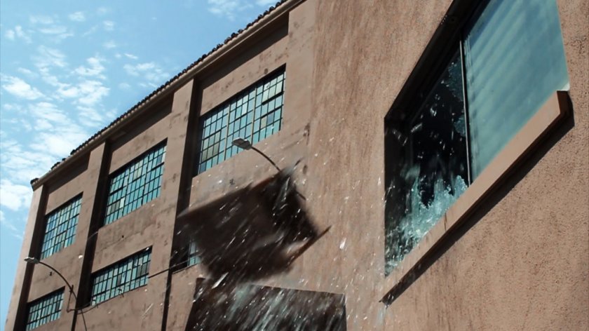 A desk thrown through a window of a HYDRA warehouse.