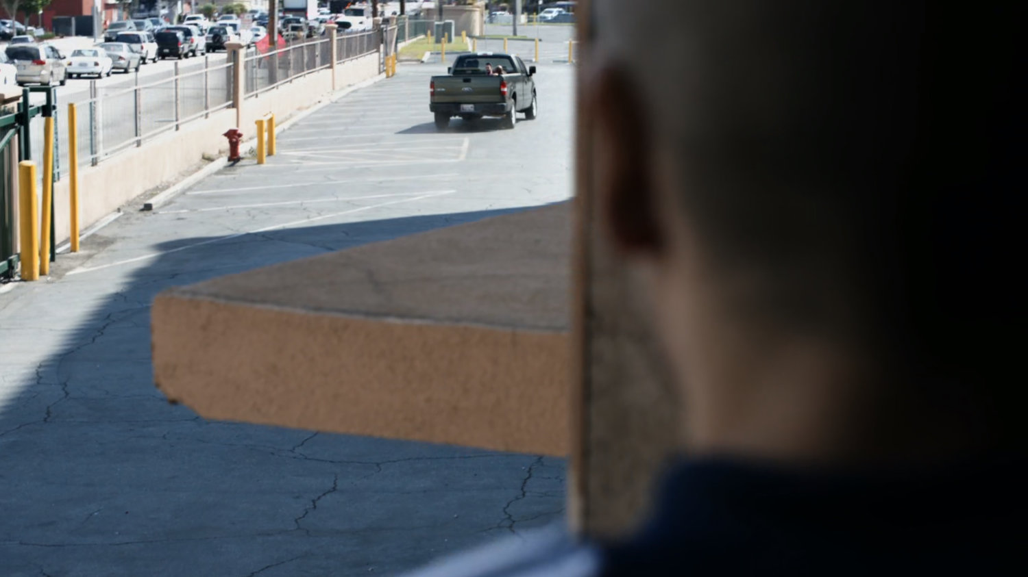 A pickup truck drives away from a HYDRA warehouse.