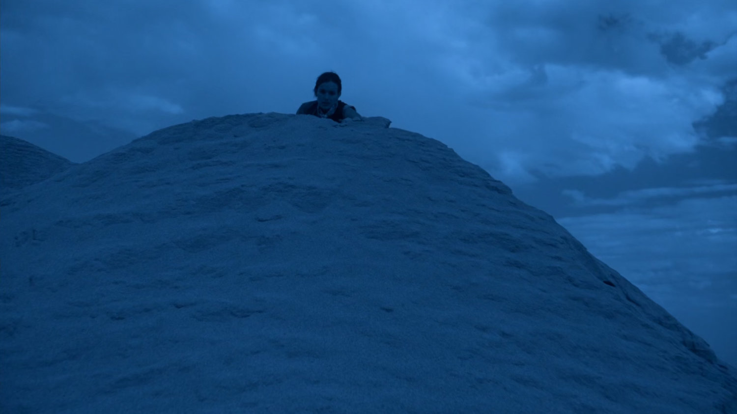 Jemma peeking over sand dune on Maveth.