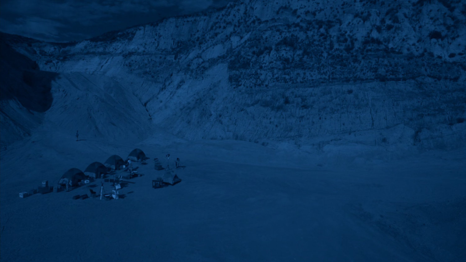 Wide shot of NASA encampment near a mountain on Maveth.