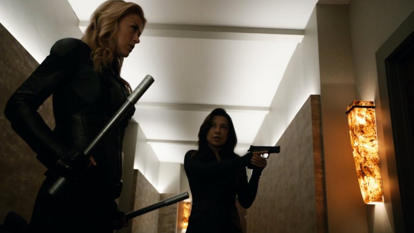 Bobbi and May about to break down a door in a Lisbon penthouse.