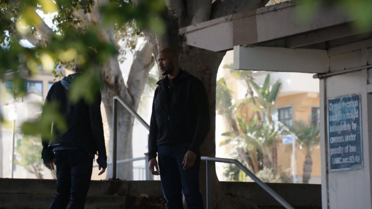 Mack talks to Lincoln on stairs at a park.