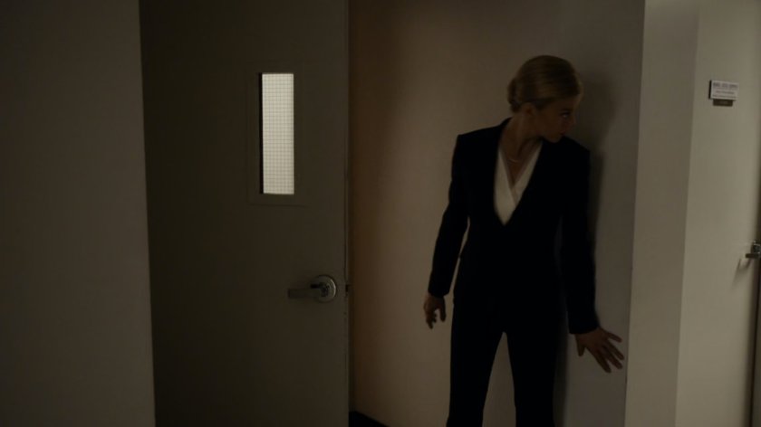 Bobbi peering around the corner of an ATCU hallway.