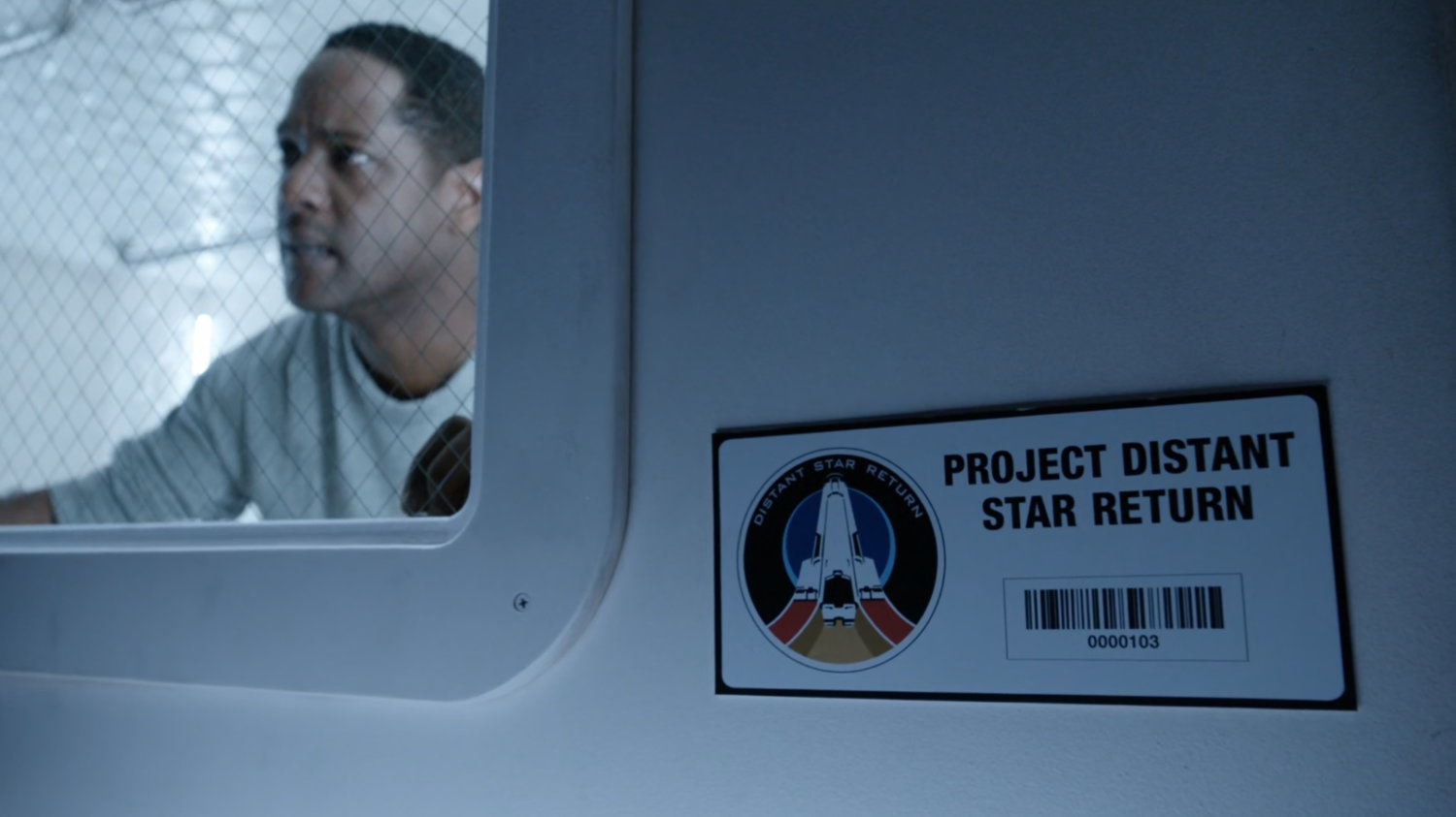 Exterior of containment module with Andrew inside. Text on plaque: Project Distant Star Return.