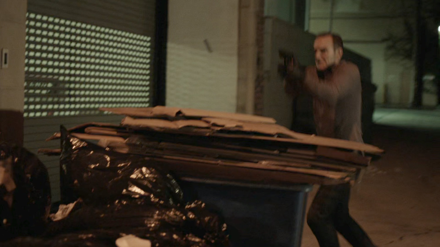 Coulson behind dumpster in alley behind Washington DC apartment.