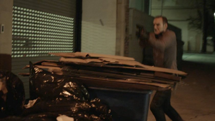 Coulson behind dumpster in alley behind Washington DC apartment.
