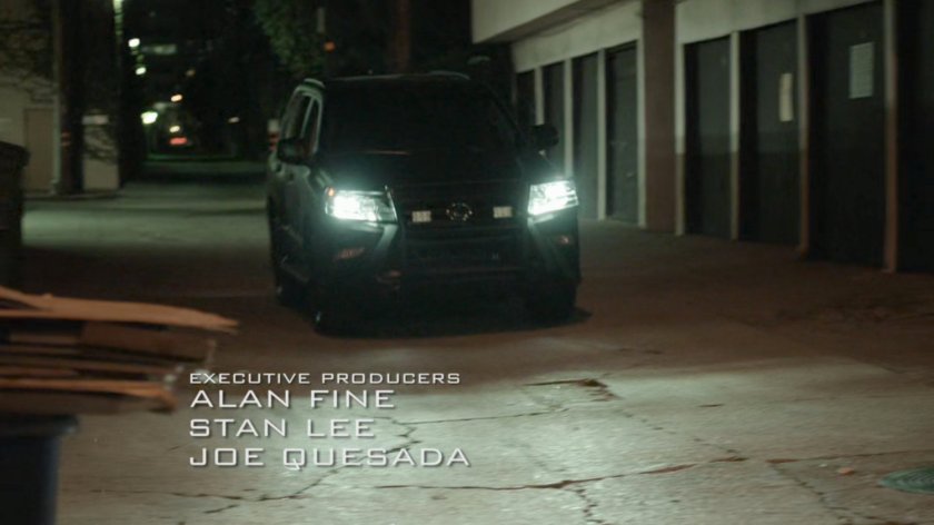 SUV driving into alley behind Washington DC apartment.