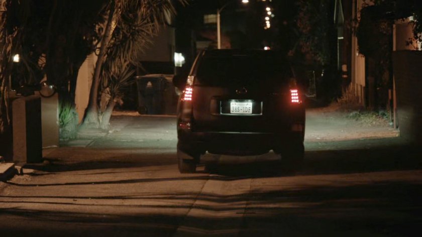 SUV driving out of alley behind Washington DC apartment.
